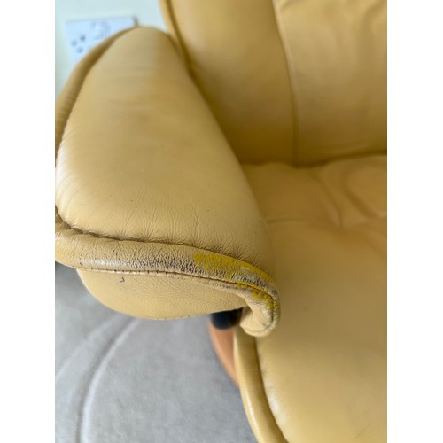 165 - Mustard coloured leather Stressless armchair and footstool.