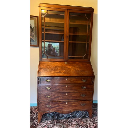 175 - A Georgian Mahogony bureau bookcase on bracket feet and fitted interior. A later two door bookcase t... 