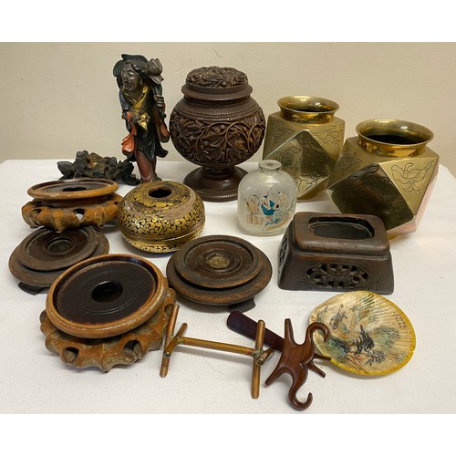 949 - Oriental items to include a pair of brass faceted vases, hard wood stands, a carved wooden lidded va... 