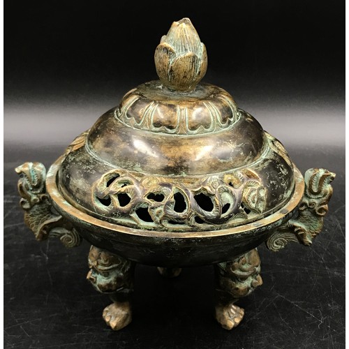 950 - A Chinese bronze incense burner, with lotus finial and dragon handles, raised on three shaped legs. ... 