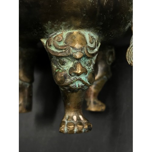 950 - A Chinese bronze incense burner, with lotus finial and dragon handles, raised on three shaped legs. ... 