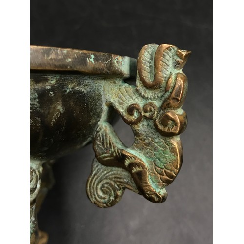 950 - A Chinese bronze incense burner, with lotus finial and dragon handles, raised on three shaped legs. ... 