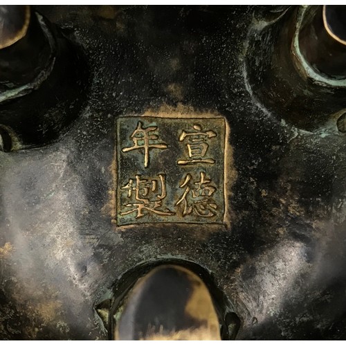 950 - A Chinese bronze incense burner, with lotus finial and dragon handles, raised on three shaped legs. ... 