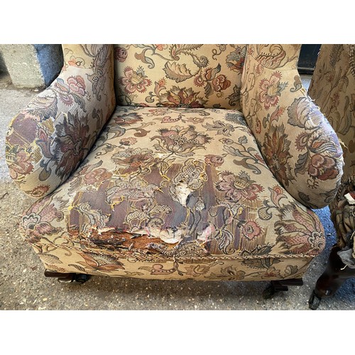 20 - Two upholstered wing back chairs on cabriole legs and castors in need of restoration. Tallest to the... 