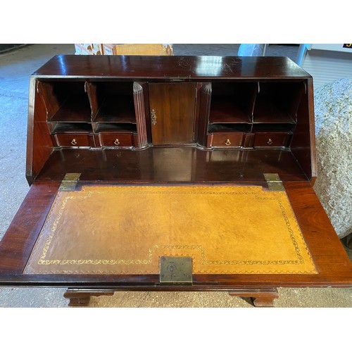 22 - A 19thC mahogany writing bureau with 4 graduating drawers on ogee bracket feet with fitted interior ... 