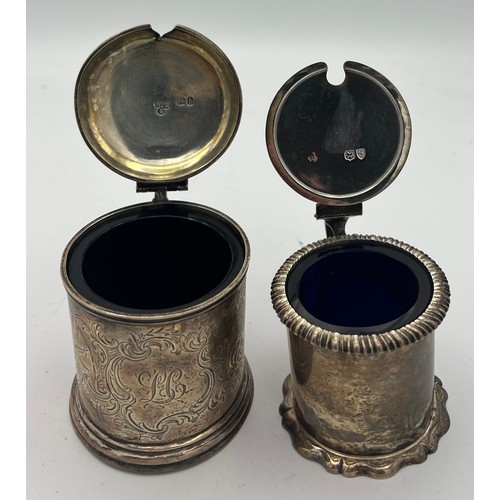 755 - Two silver mustard pots with blue glass liners and one mustard spoon. London 1857, maker William Rob... 