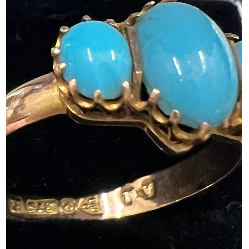 600 - A nine carat gold ring set with three turquoise stones. Size N. Weight 1.2gm.