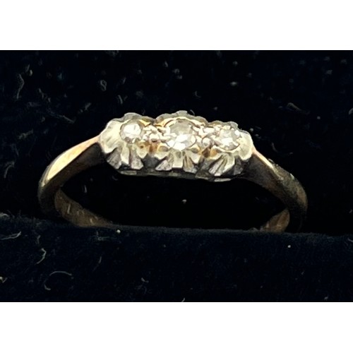 602 - A three stone diamond ring set in 9 carat gold and platinum. Size J. Weight 1.4gm.