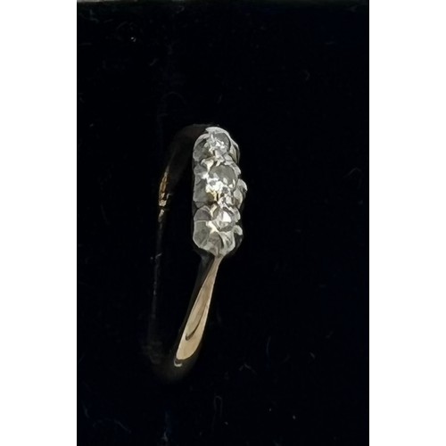 602 - A three stone diamond ring set in 9 carat gold and platinum. Size J. Weight 1.4gm.