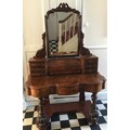 A Victorian figured walnut dressing table with frieze drawers, swivel mirror, seven drawers to top a... 