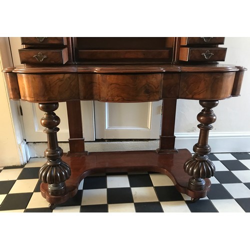 28 - A Victorian figured walnut dressing table with frieze drawers, swivel mirror, seven drawers to top a... 