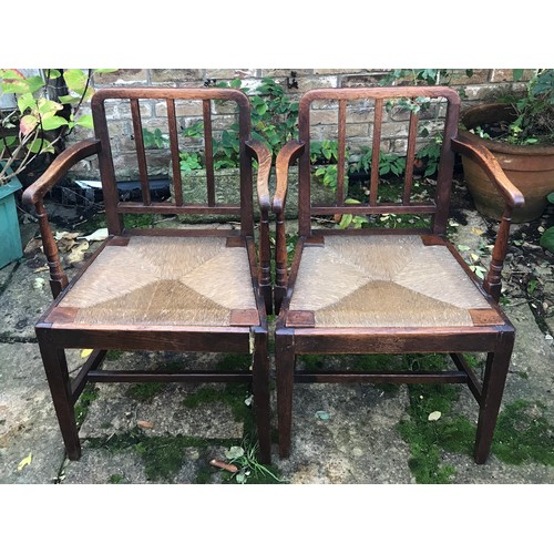 13 - A set of 7 early 20thC oak and rush seated dining chairs.