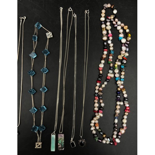 458 - A collection of 11 necklaces to include a string of multi-coloured pearls, 2 silver enamel chains, 2... 