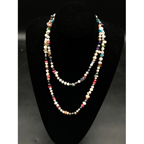 458 - A collection of 11 necklaces to include a string of multi-coloured pearls, 2 silver enamel chains, 2... 