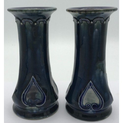 373 - A pair of Royal Doulton stoneware vases by Maud Bowden, each decorated with an inverted Art Nouveau ... 