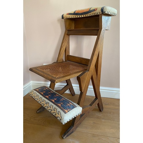 41 - A 19thC oak chair with upholstered footrest and top with cane seat.