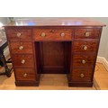A 19thC mahogany kneehole desk with brass knobs and central cupboard 108 w x 52 d x 85cm h.
