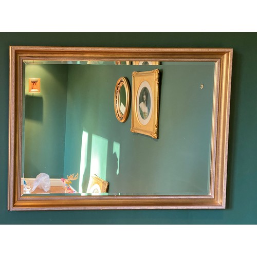 1151 - A 20thC gilt framed bevel edged mirror 70 h x 101cm w.