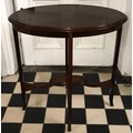 An Edwardian mahogany oval side table with a cross banded inlaid top.