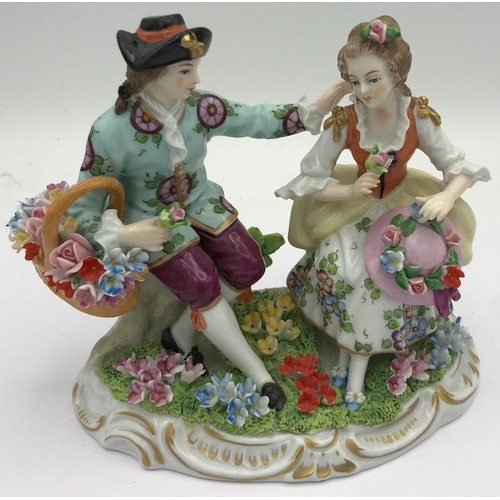 378 - A Sitzendorf figure of a couple sitting together with flowers