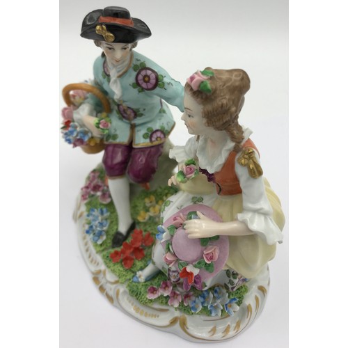 378 - A Sitzendorf figure of a couple sitting together with flowers