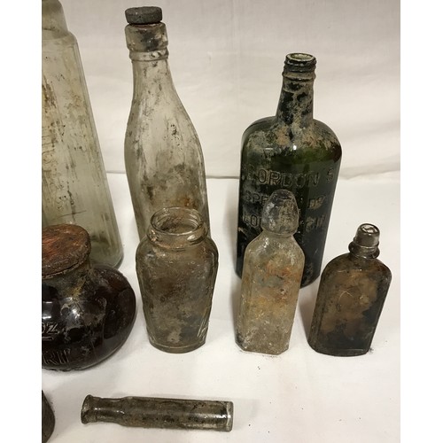 432 - A collection of glass bottles to include three 16oz Bovril, Gordon's special dry London gin and an E... 