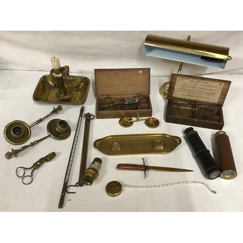 1047 - A selection of brass items to include chamber stick, three coin balances, pen tray, letter opener, t... 