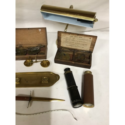 1047 - A selection of brass items to include chamber stick, three coin balances, pen tray, letter opener, t... 