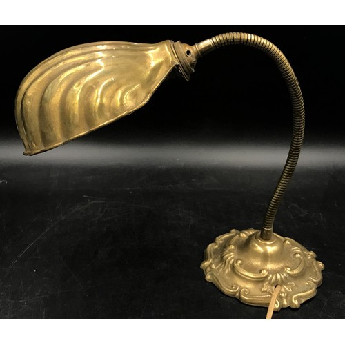 1129 - A brass desk lamp with shell shaped shade and adjustable neck measuring 55cm h.