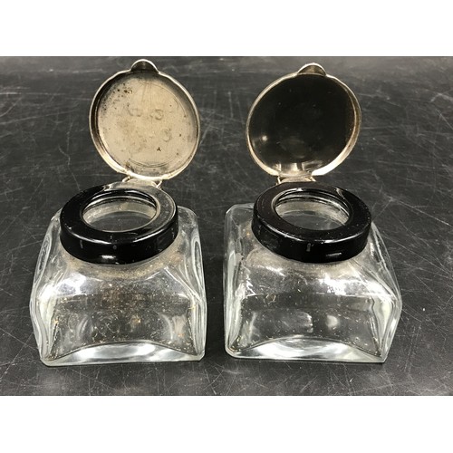 438 - Two pairs of glass ink wells to include one pair of Victorian inks with brass tops the other pair wi... 