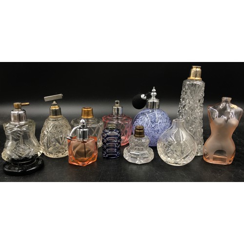 439 - A collection of 11 scent bottles of various size and shape tallest 51cm h also with a quantity of to... 