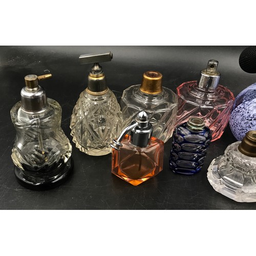 439 - A collection of 11 scent bottles of various size and shape tallest 51cm h also with a quantity of to... 