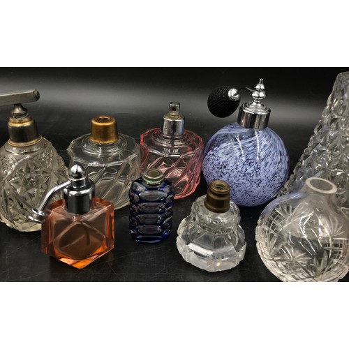 439 - A collection of 11 scent bottles of various size and shape tallest 51cm h also with a quantity of to... 