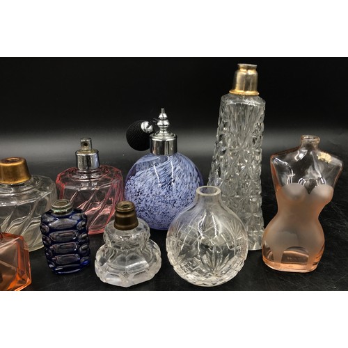 439 - A collection of 11 scent bottles of various size and shape tallest 51cm h also with a quantity of to... 