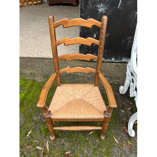 11 - A good quality 20thC rush seated ladder backed child's chair. 74cm h.