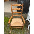 A good quality 20thC rush seated ladder backed child's chair. 74cm h.