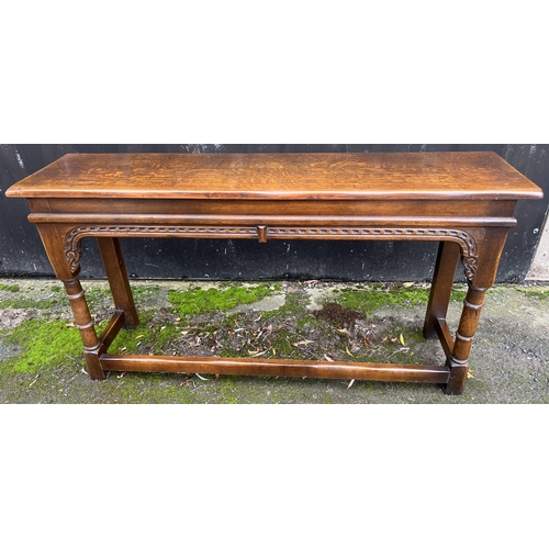 12 - A good quality 20thC oak side table with carved frieze, turned legs and stretchers to front and side... 