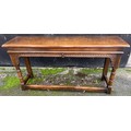 A good quality 20thC oak side table with carved frieze, turned legs and stretchers to front and side... 