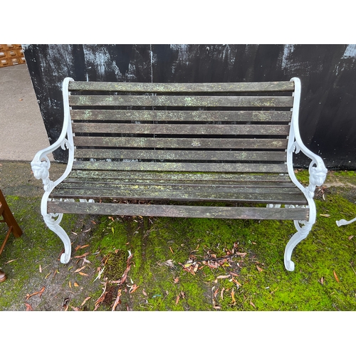 185 - A decorative metal and wooden garden bench. 126cm w.