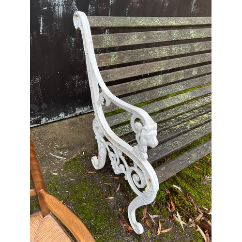 185 - A decorative metal and wooden garden bench. 126cm w.