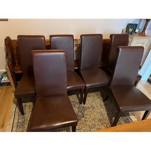 6 - Six high back brown leather upholstered dining chairs on square tapered legs.