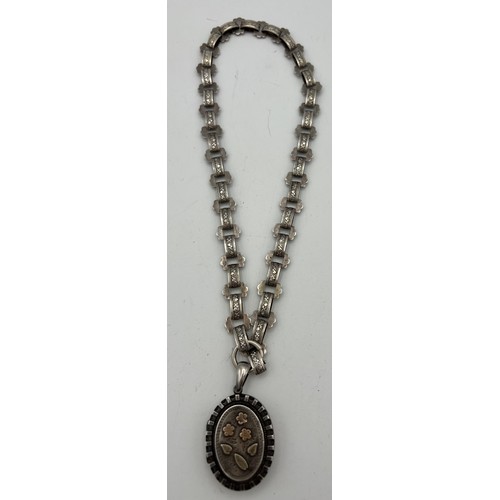 489 - Victorian silver  locket on white metal chain. Birmingham 1883.  Maker Adie and Lovekin. Total weigh... 