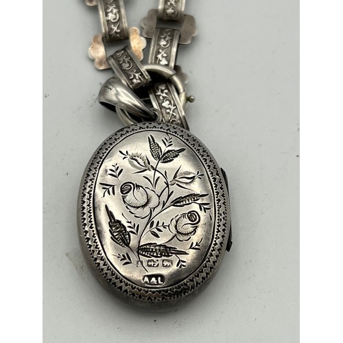 489 - Victorian silver  locket on white metal chain. Birmingham 1883.  Maker Adie and Lovekin. Total weigh... 