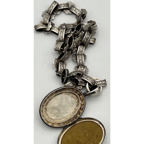 489 - Victorian silver  locket on white metal chain. Birmingham 1883.  Maker Adie and Lovekin. Total weigh... 