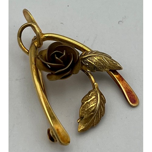 524 - Nine carat gold wishbone and rose brooch.Weight 3.9g.