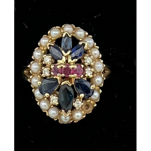 508 - A 14 carat gold ring set with seed pearls, sapphires, diamonds and rubies. Size O. Weight 5.6gm.