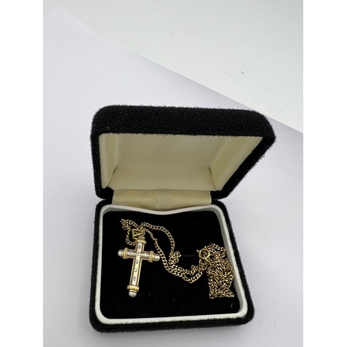 510 - Fourteen carat white and yellow gold crucifix set with diamonds on a 9 carat yellow gold chain. Leng... 