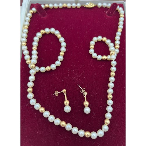 512 - Cultured pearl single strand necklace with 14 carat gold clasp. Length 70cm with matching earrings.