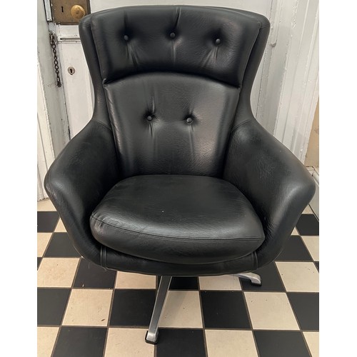 87 - Mid century swivel armchair covered in black faux leather.