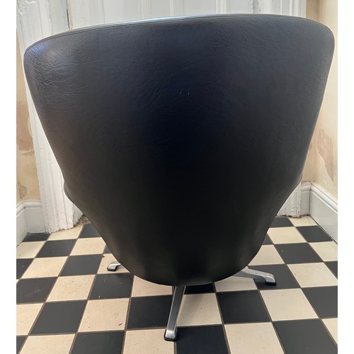 87 - Mid century swivel armchair covered in black faux leather.